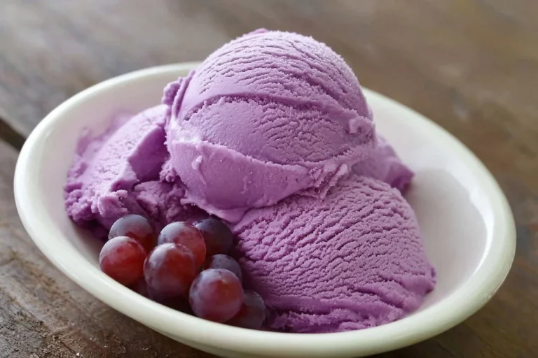 Delicious grape juice ice cream in a bowl with fresh grapes