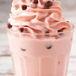 Delicious homemade Watermelon Dole Whip served in a bowl with a slice of watermelon.