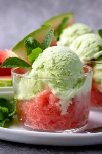 Delicious bowl of fresh mint ice cream topped with mint leaves.