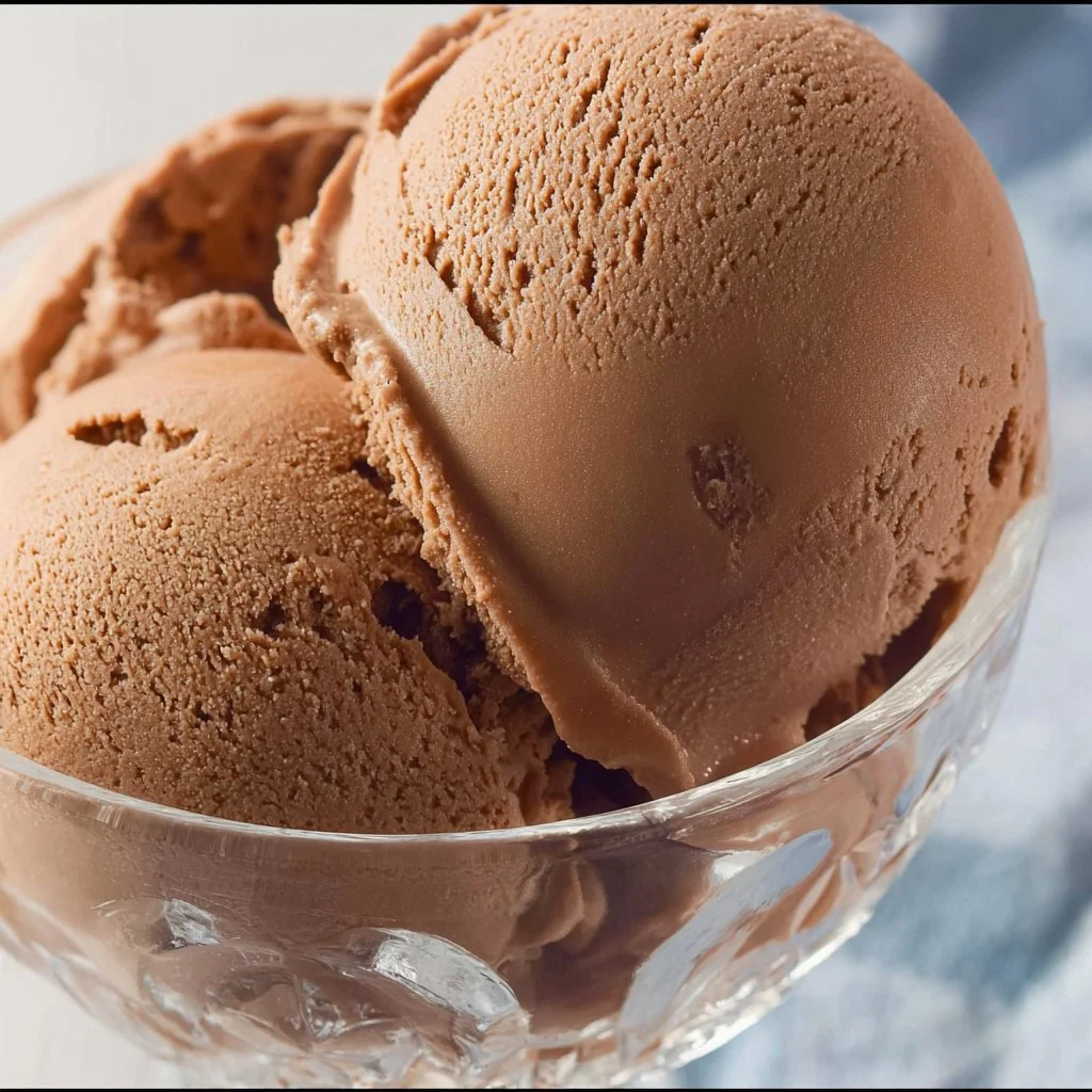 Bowl of Ninja Creami dairy free chocolate ice cream with toppings