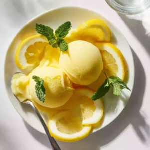 Delicious Ninja Creami lemon sorbet served in a bowl with lemon slices