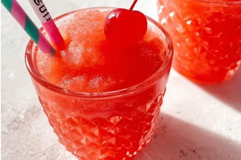 A delicious Shirley Temple Slushie served with a cherry on top.