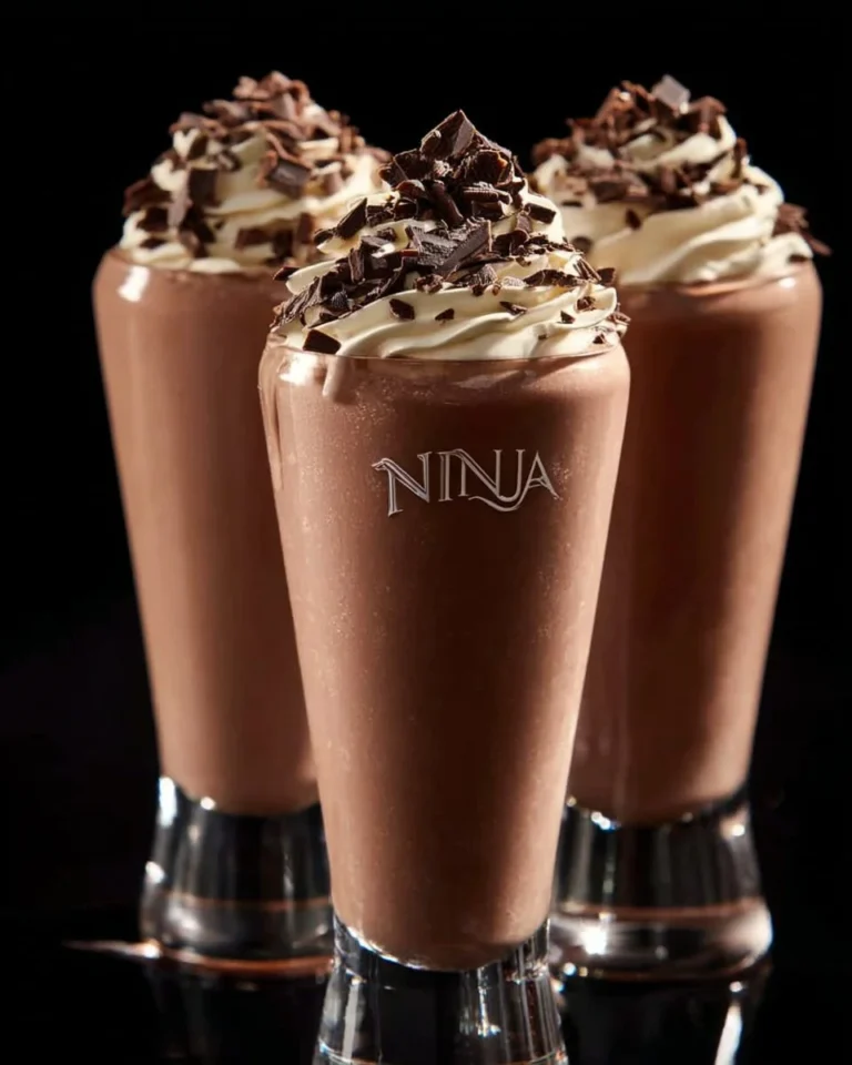 Ninja Creami chocolate milkshake topped with whipped cream and chocolate drizzle.