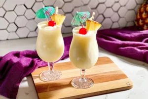 Delicious Pineapple Colada Ninja Slushi Granita served in a glass with tropical garnish.