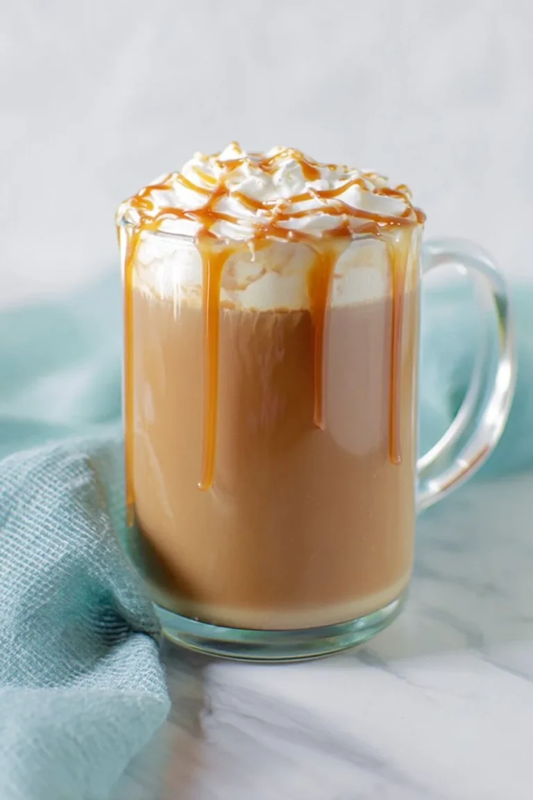 Delicious Caramel Mocha in a coffee cup with whipped cream and caramel drizzle.
