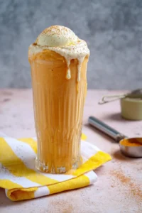 Delicious easy pumpkin milkshake topped with whipped cream and a sprinkle of cinnamon