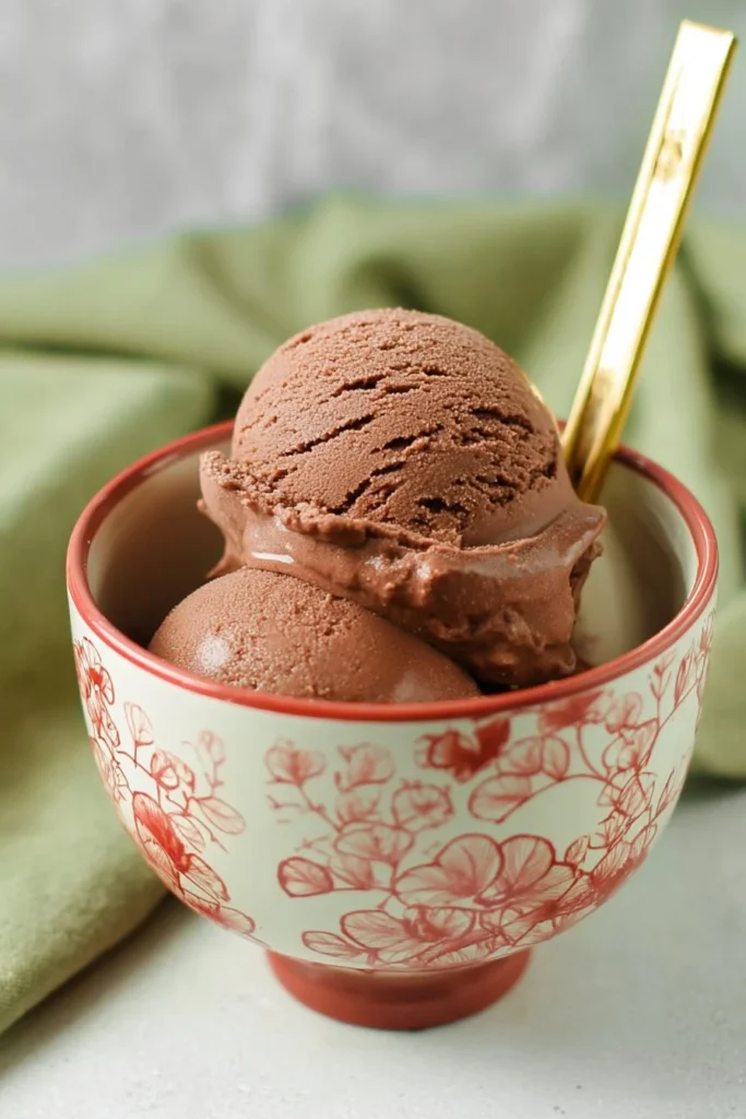 Ninja Creami Lite Chocolate Pudding Ice Cream served in a bowl with toppings.